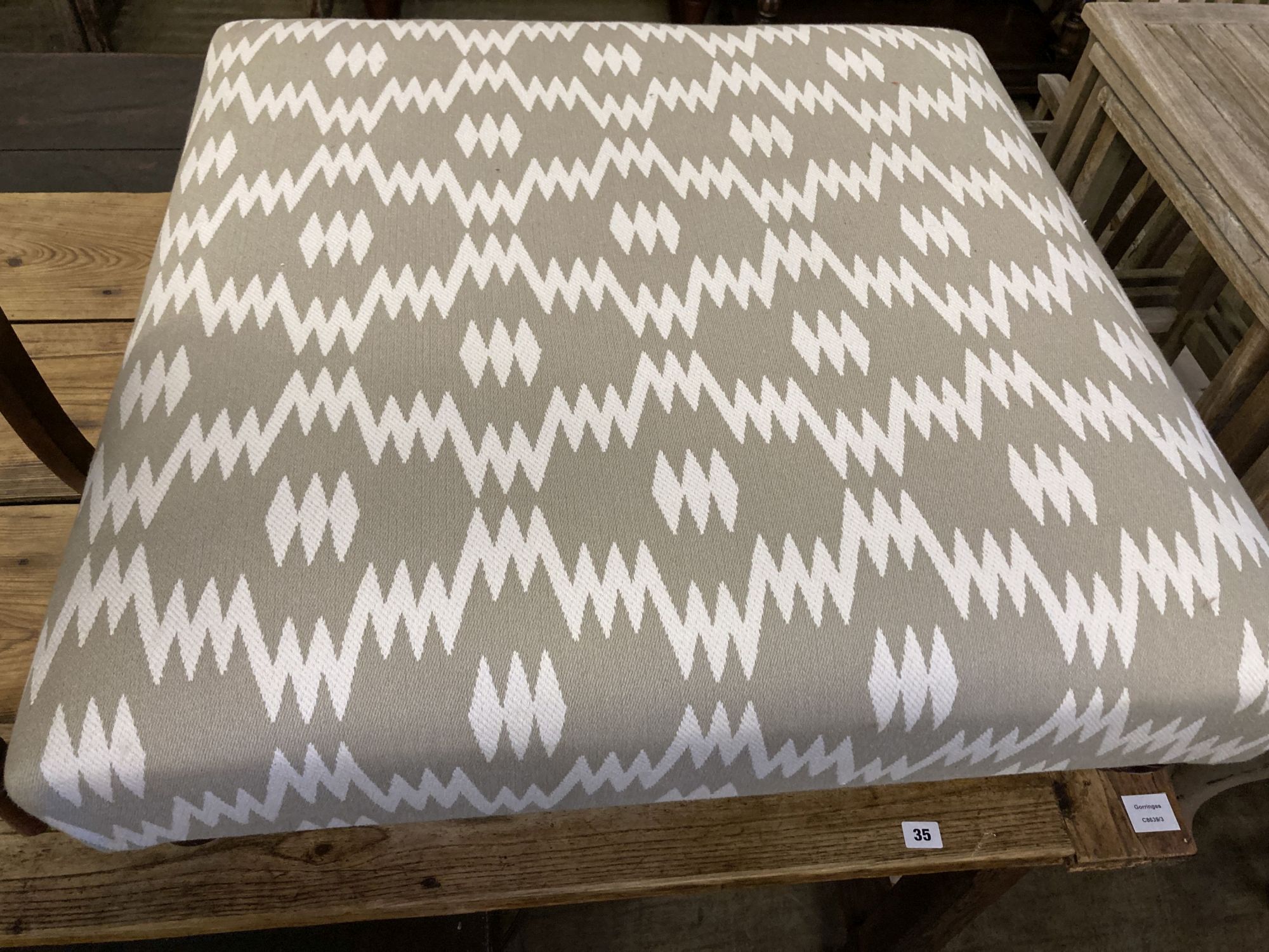 A contemporary Victorian style footstool upholstered in grey / ivory fabric, length 85cm, depth 85cm, height 28cm